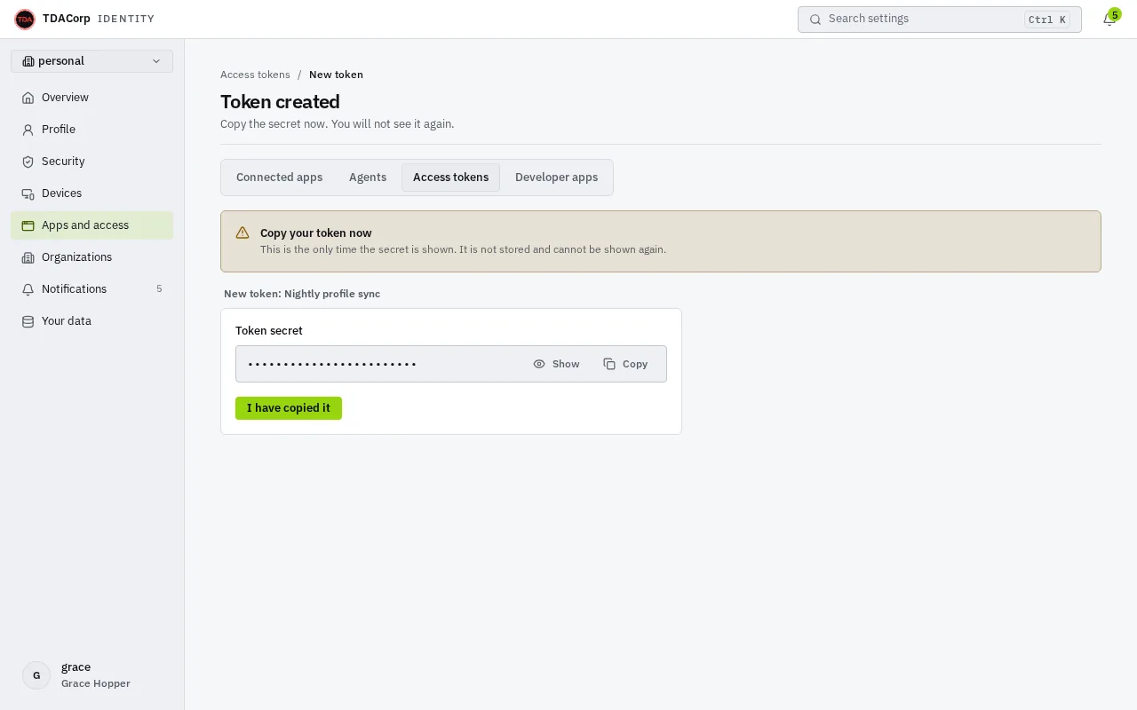 The Token created page: a notice to copy the token now because it is shown only once, the secret hidden in a Token secret field with Show and Copy buttons, and an I have copied it button.